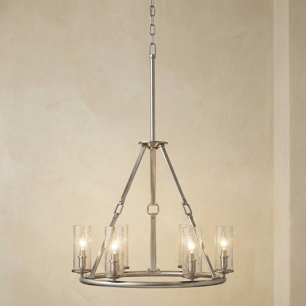 Hinkley Dakota 6-light chandelier in polished antique nickel with seeded glass shades against a neutral wall.