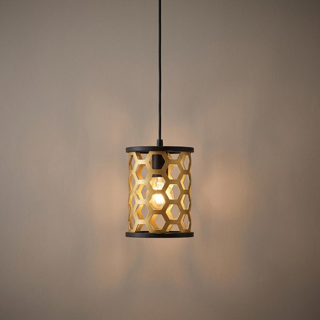 A gold honeycomb patterned mini pendant light with black accents suspended against a neutral background.