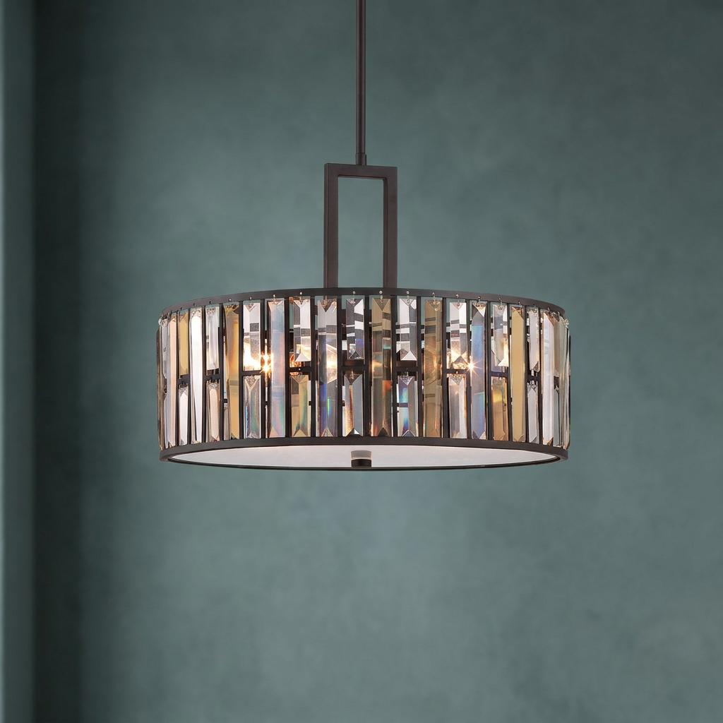 Hinkley Gemma vintage bronze pendant light with amber and clear crystals against a dark teal wall.