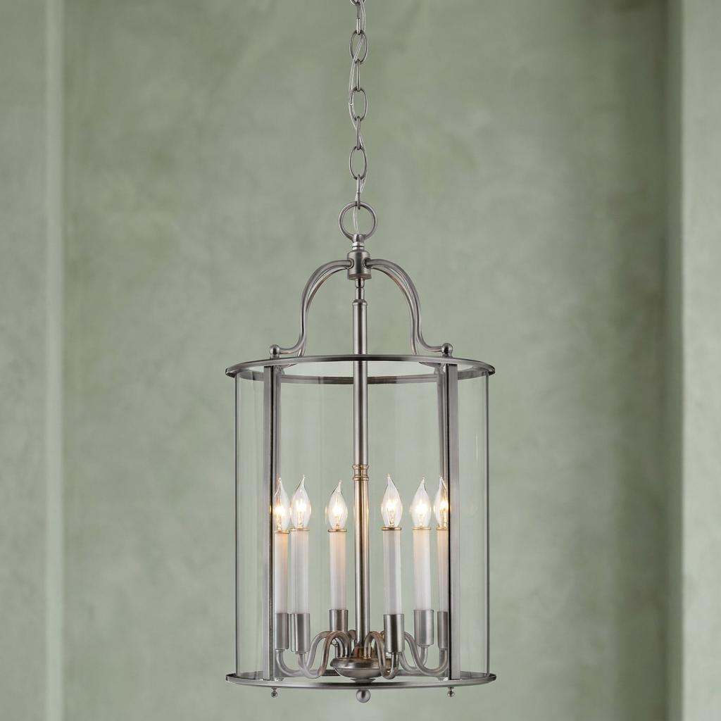 Hinkley Gentry 6-light pewter chandelier with a cylindrical glass frame and candle-style bulbs.
