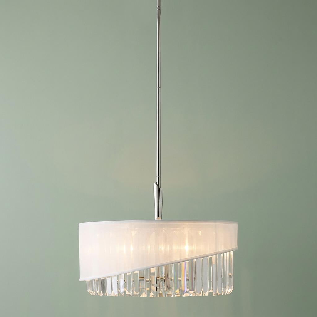 Polished nickel pendant light with an angled white fabric shade and faceted crystal drops against a sage green wall.