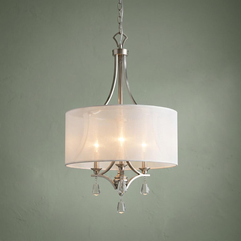 Hinkley Mime 3-light brushed nickel pendant with a white drum shade and crystal accents against a sage green wall.