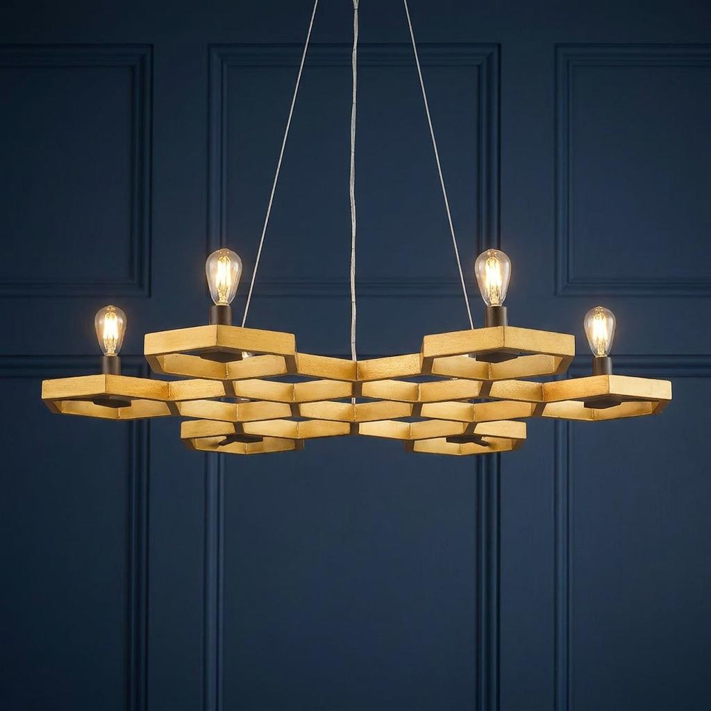 Hinkley Moxie 6 light gold geometric chandelier with a honeycomb frame and Edison bulbs against a navy blue wall.