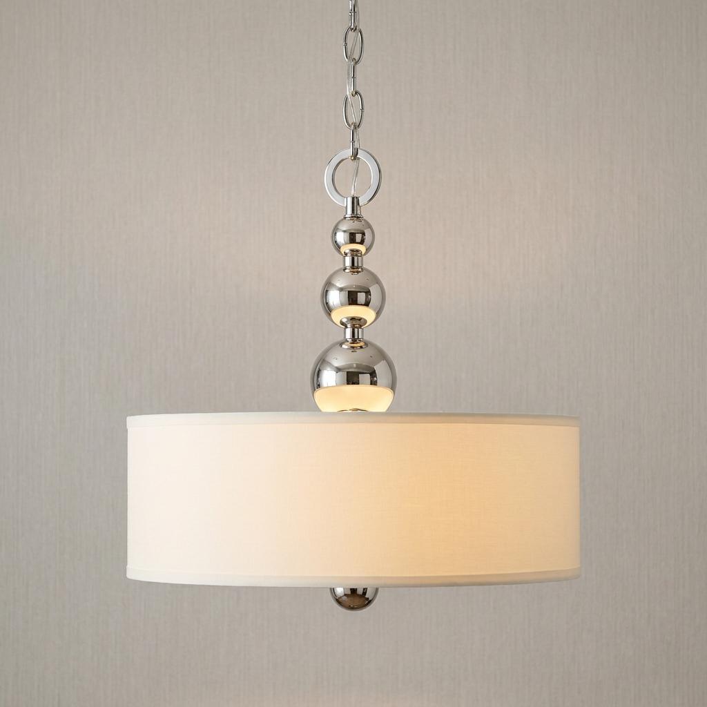Polished nickel pendant light with a white drum shade and decorative tiered spherical accents.