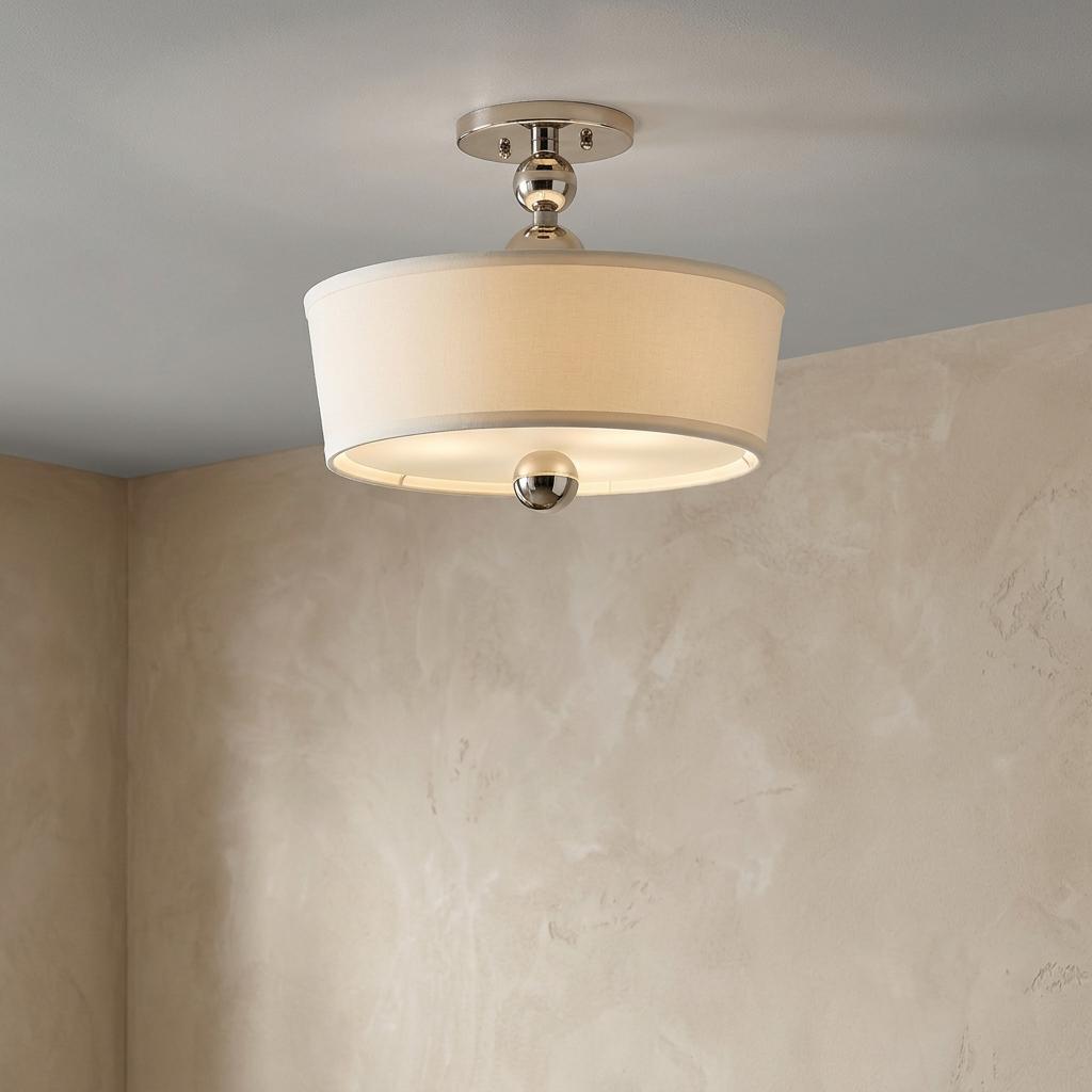 Hinkley Zelda polished nickel semi-flush mount light with an off-white fabric drum shade on a textured wall.