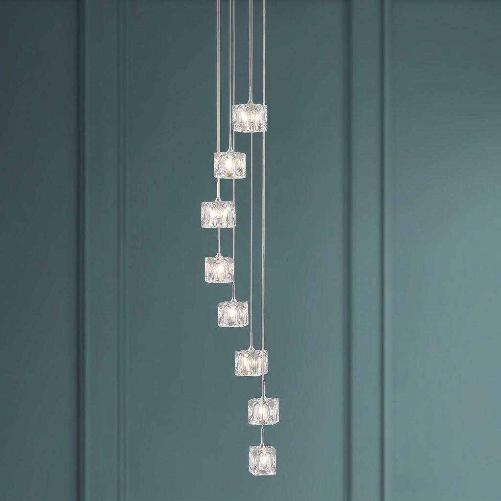 An 8-light LED multi-drop pendant featuring glass ice cube shades in a spiral arrangement against a teal wall.