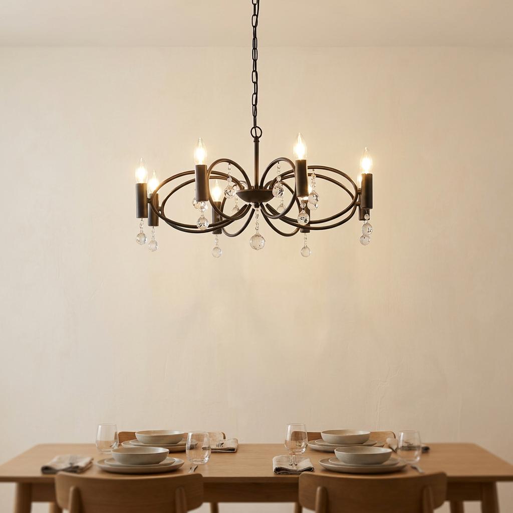 Eight-light black pendant with crystal droplets hanging above a minimalist wooden dining table.