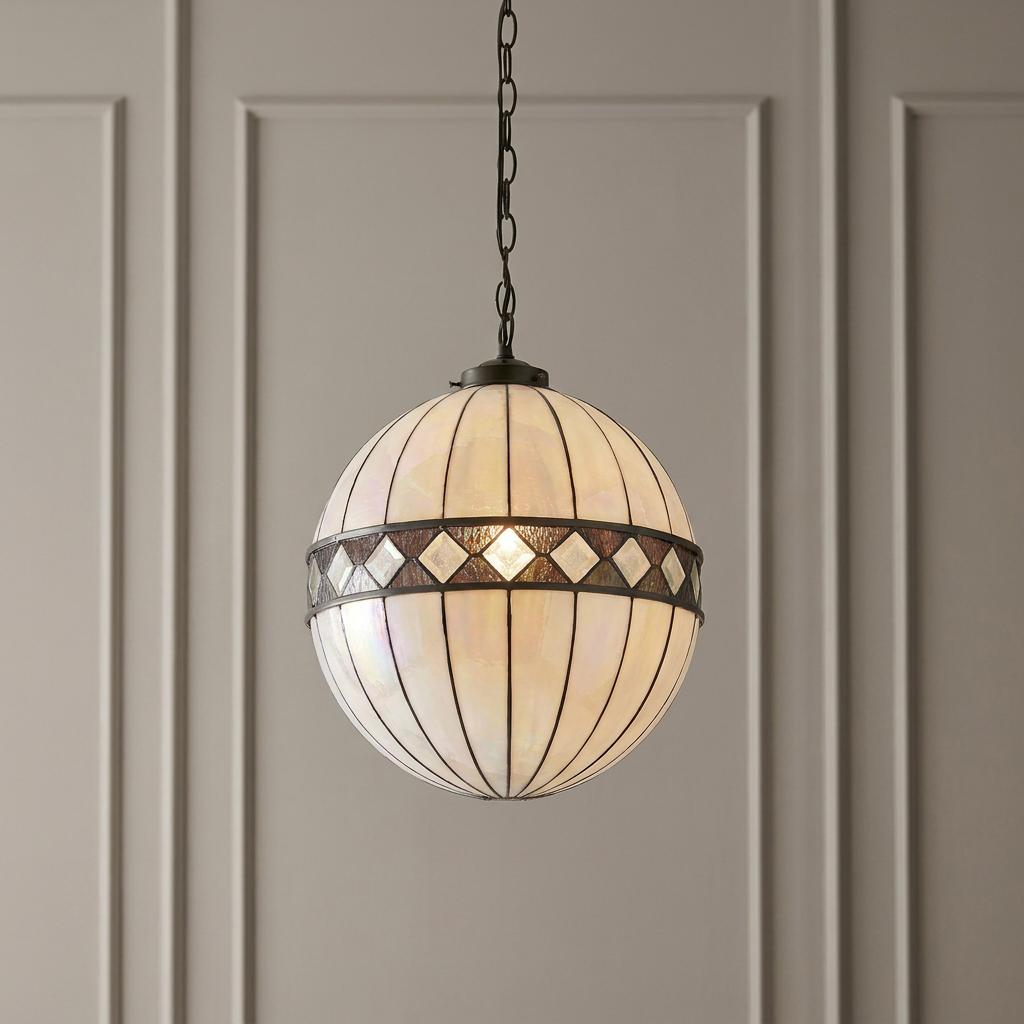 Interiors 1900 Fargo Medium Tiffany Globe Ceiling Light with iridescent glass panels against a paneled wall.