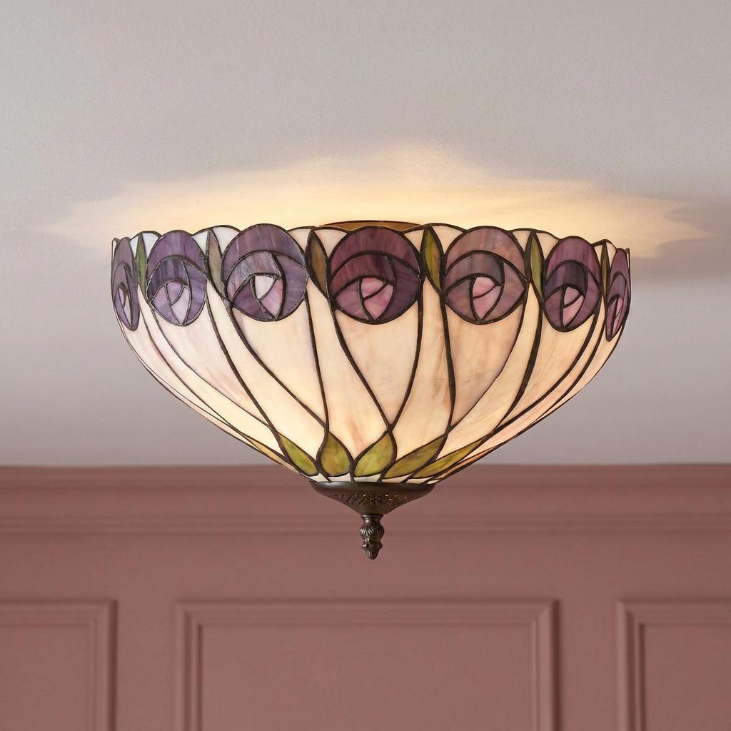 Tiffany-style flush ceiling light with purple rose patterns and green leaves, casting a warm glow on a white ceiling.