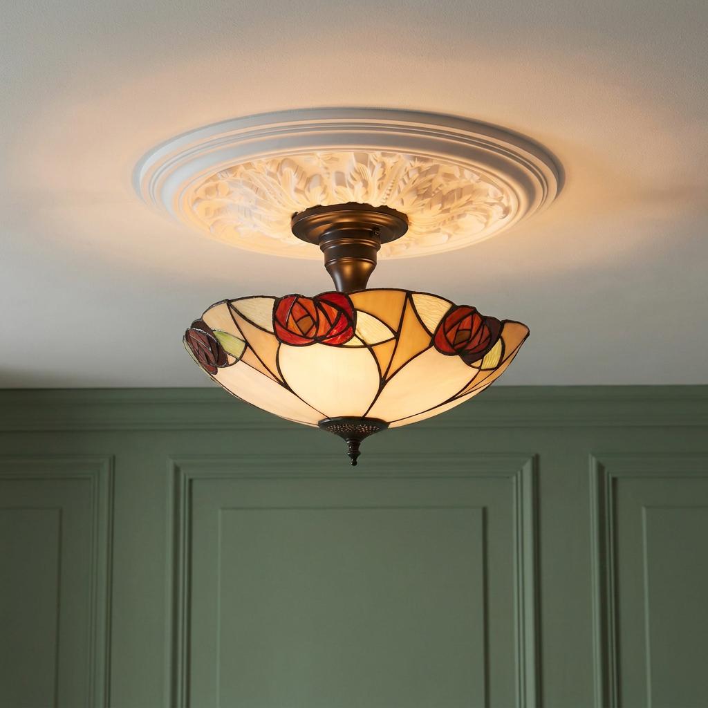 Tiffany semi-flush ceiling light with a red rose glass shade on an ornate white ceiling rose.