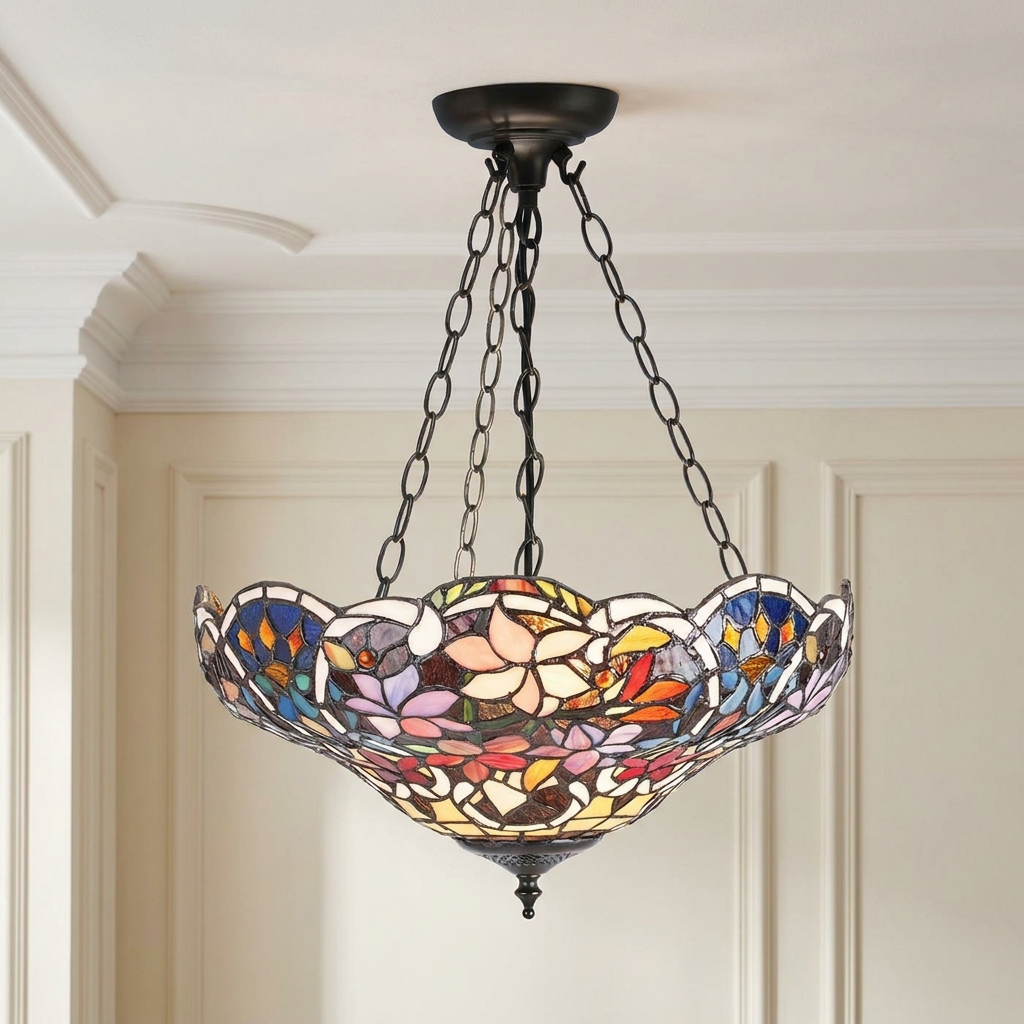 Inverted Tiffany ceiling light with floral stained glass hanging by bronze chains in a classic room.