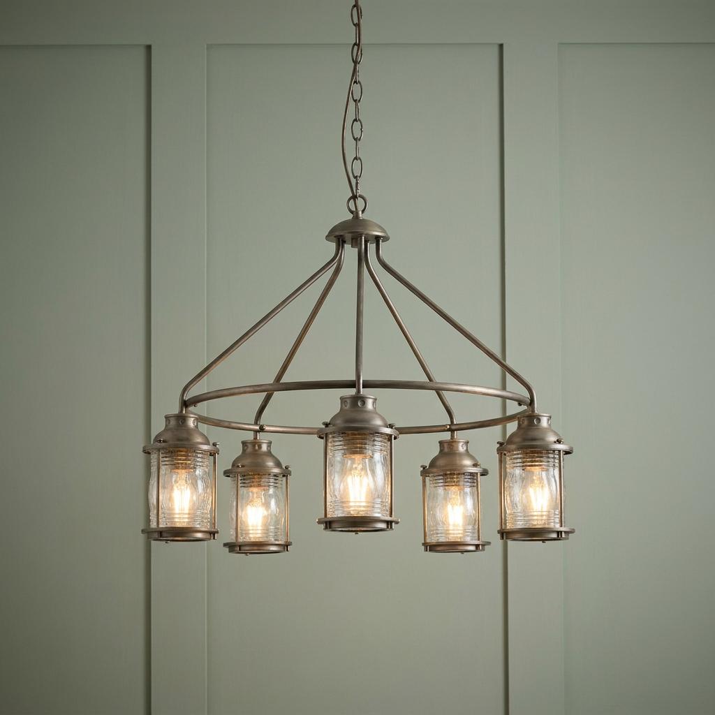 Kichler Ashland Bay five-light bronze chandelier with ribbed glass shades hanging against a sage green paneled wall.