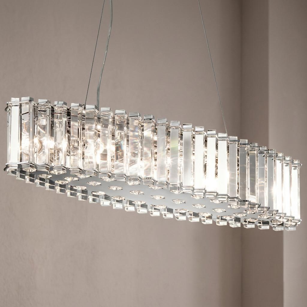 Kichler Crystal Skye island pendant light with vertical crystal prisms and chrome finish, glowing in a room.