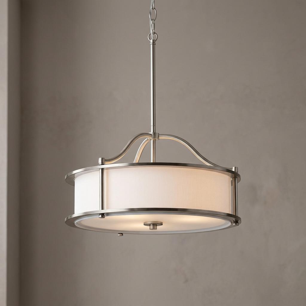 Transitional pewter semi-flush pendant light featuring a white fabric drum shade and elegant curved metal frame.