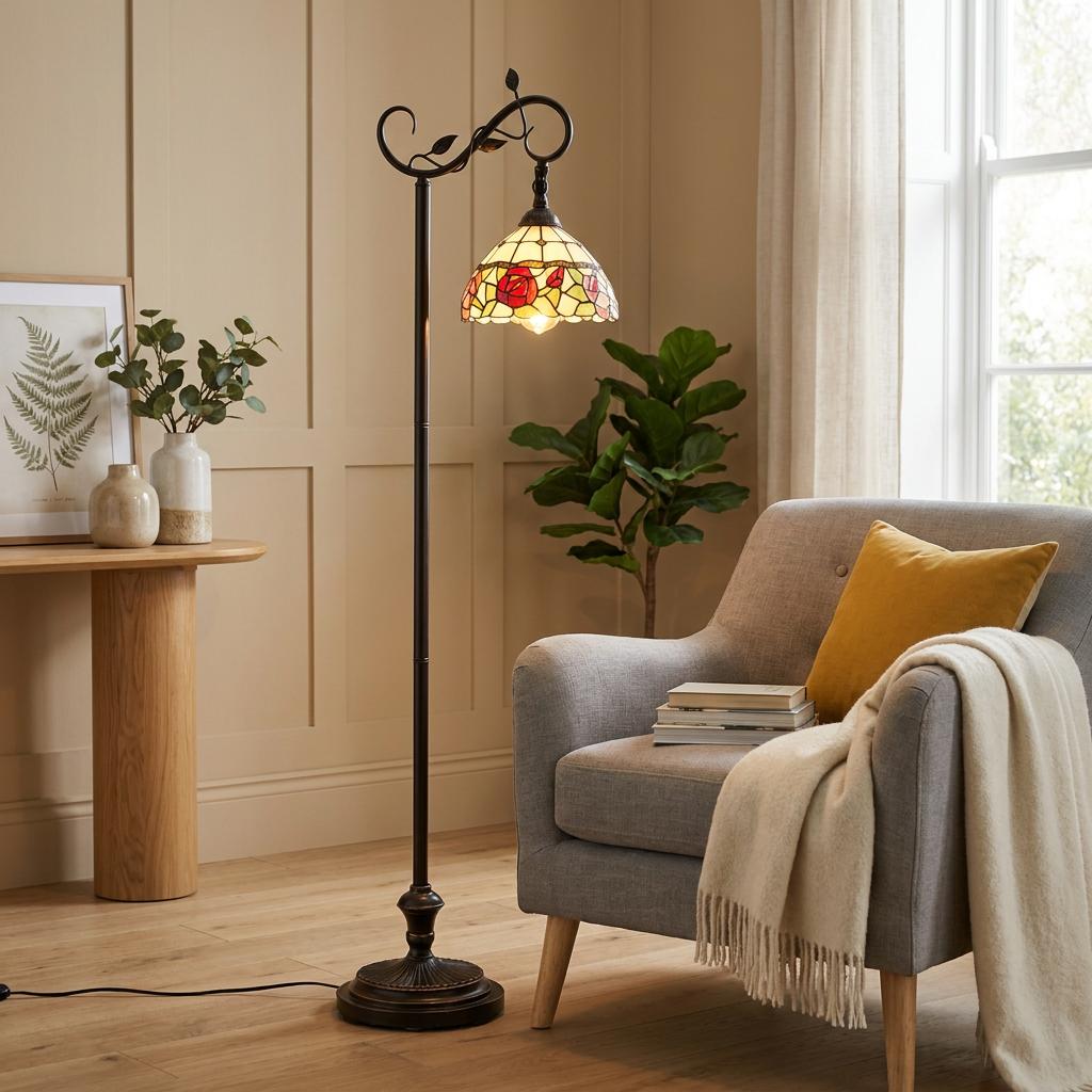 Leicester Tiffany floor lamp with a red rose glass shade next to a grey armchair in a cozy living room.