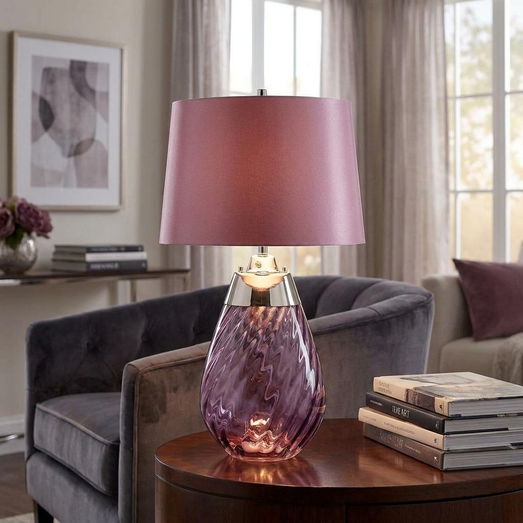 Lena small plum glass table lamp with a tapered mauve shade on a wooden table in a stylish living room.