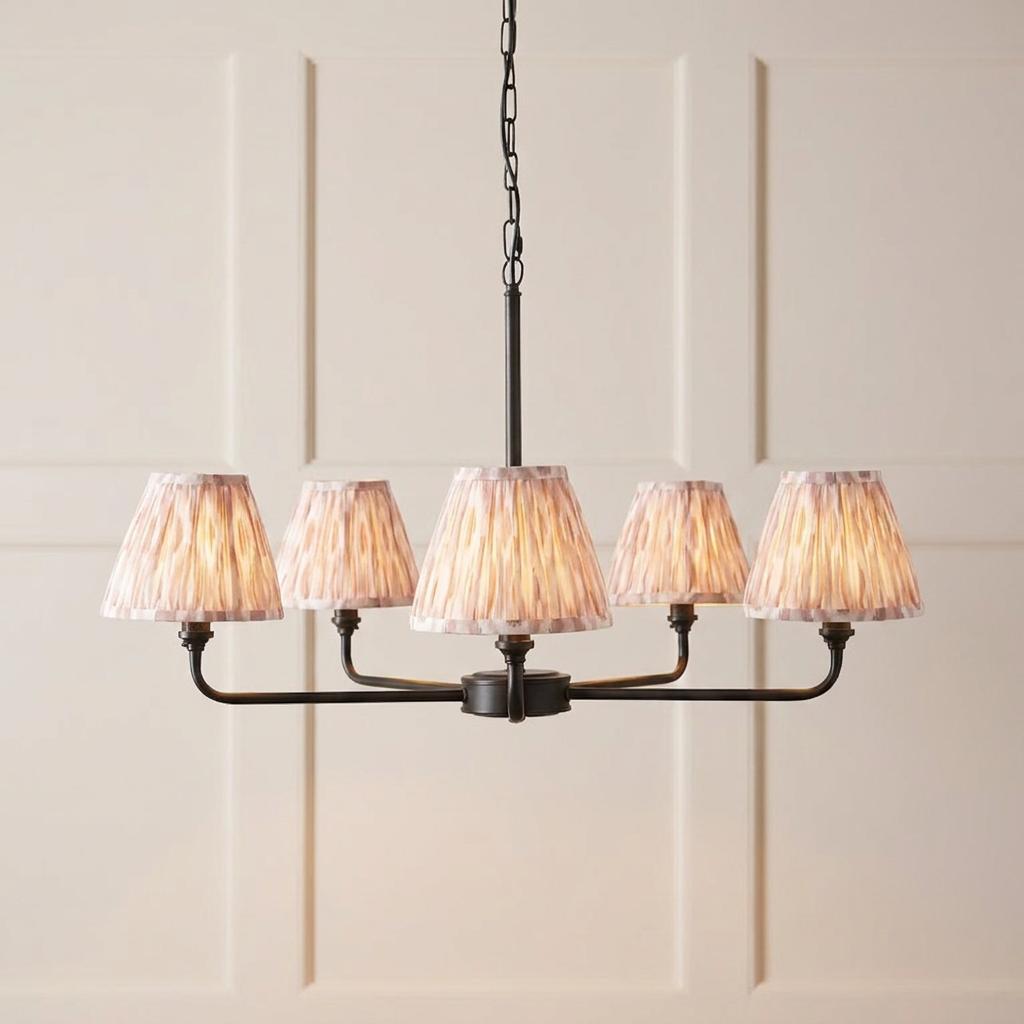 Lille black 5-light pendant with neutral ikat fabric shades against a cream paneled wall.