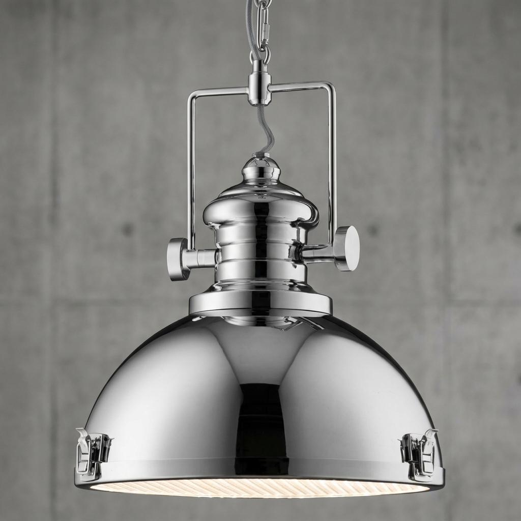Polished chrome industrial searchlight pendant with a dome shade and decorative clasps against a concrete wall.