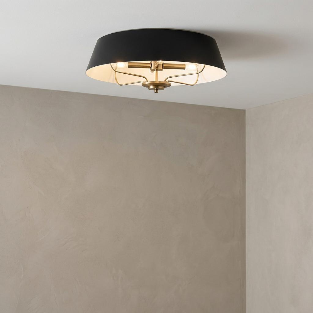 Modern flush ceiling light featuring a black drum shade and brass interior frame against a neutral textured wall.