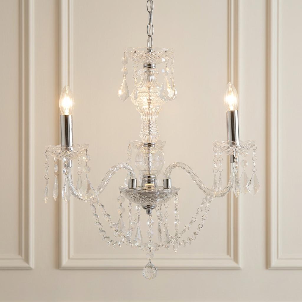 Marie Therese 3-light acrylic chandelier with clear droplets and glowing bulbs against a paneled wall.