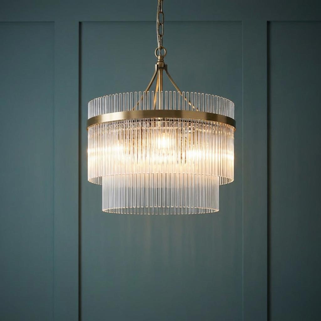 Marietta brass 3-light ceiling pendant with tiered glass rods hanging against a dark teal paneled wall.