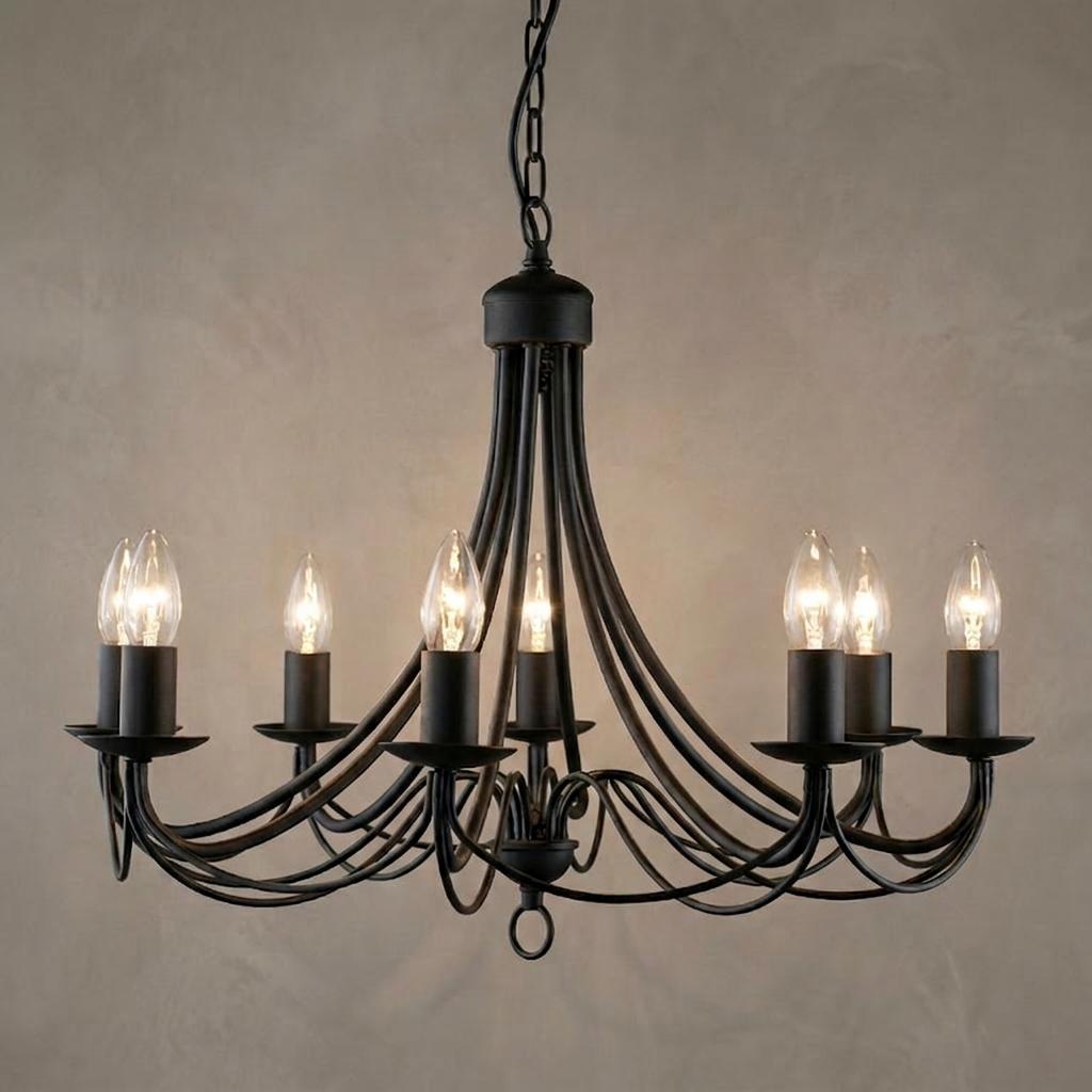 Maypole 8-light matt black wrought iron ceiling pendant with lit candle bulbs and elegant curved arms.