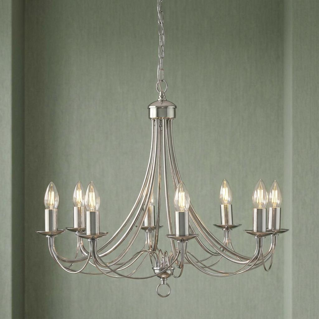 Maypole 8-light satin silver chandelier with elegant curved arms and candle bulbs against a green wall.