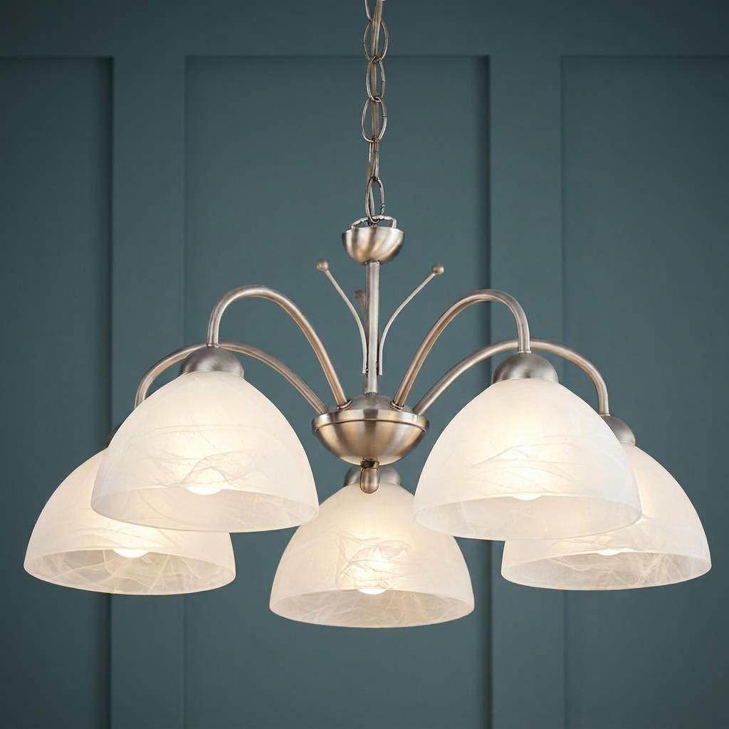 Milanese five-light metal ceiling pendant with dome-shaped alabaster glass shades against a blue paneled wall.