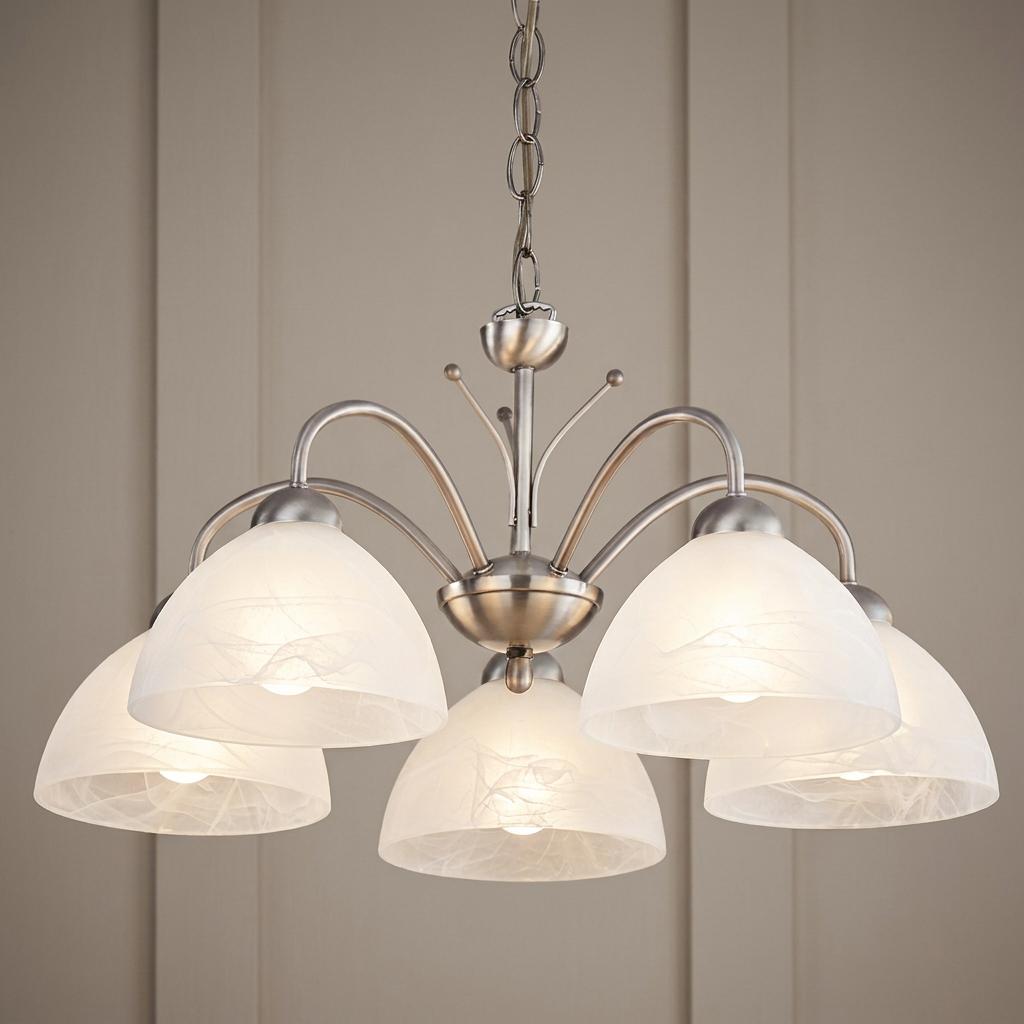Five-light satin nickel chandelier with white alabaster glass shades hanging against a neutral paneled wall.