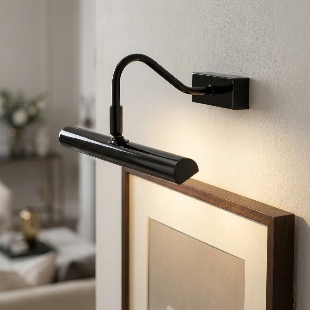 Sleek mirror black picture light with a curved arm illuminating a wooden frame on a white wall.