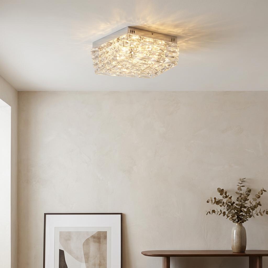 Square chrome flush ceiling light with clear crystal glass facets illuminated in a modern interior setting.