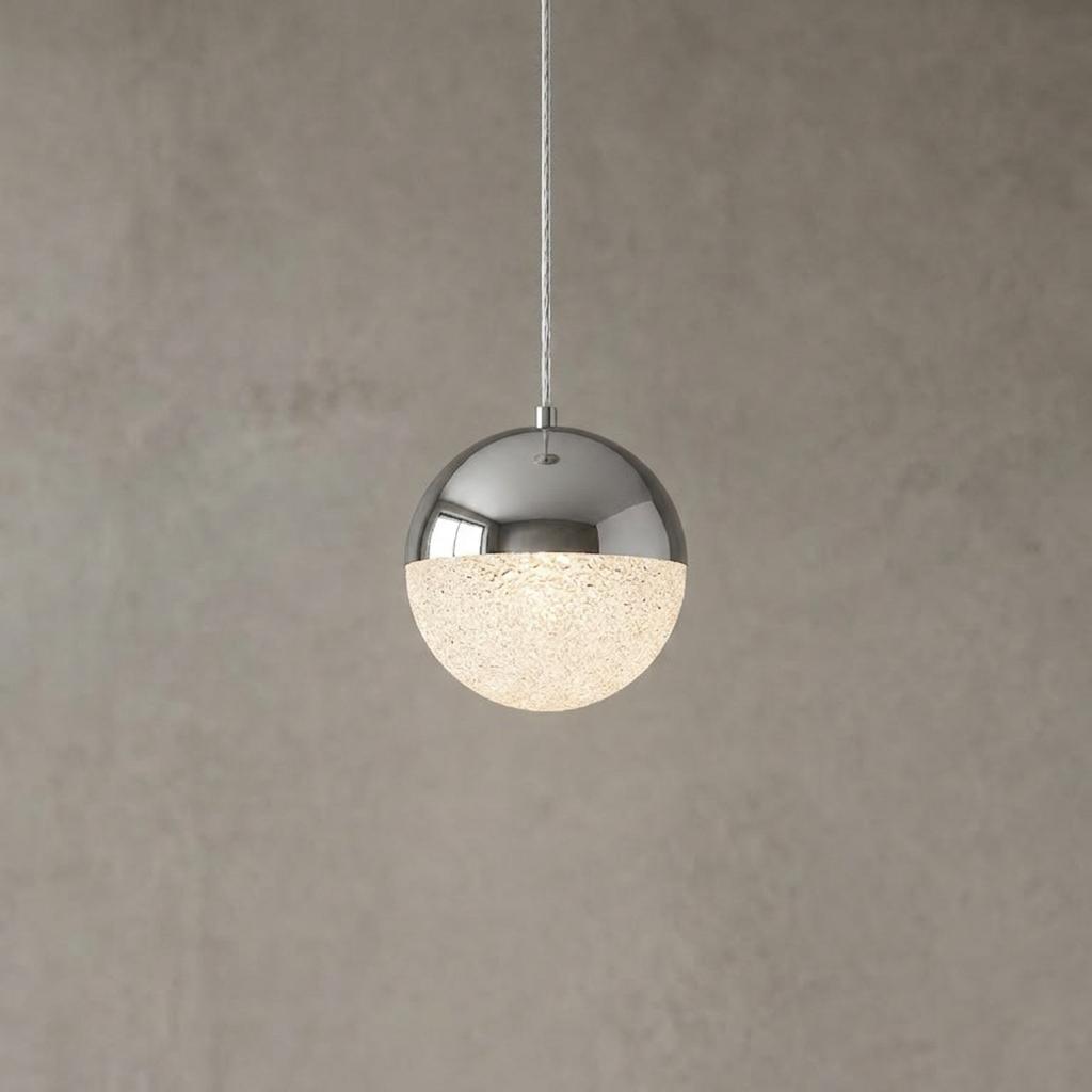 Spherical pendant light featuring a polished chrome top and an illuminated textured glass bottom half.