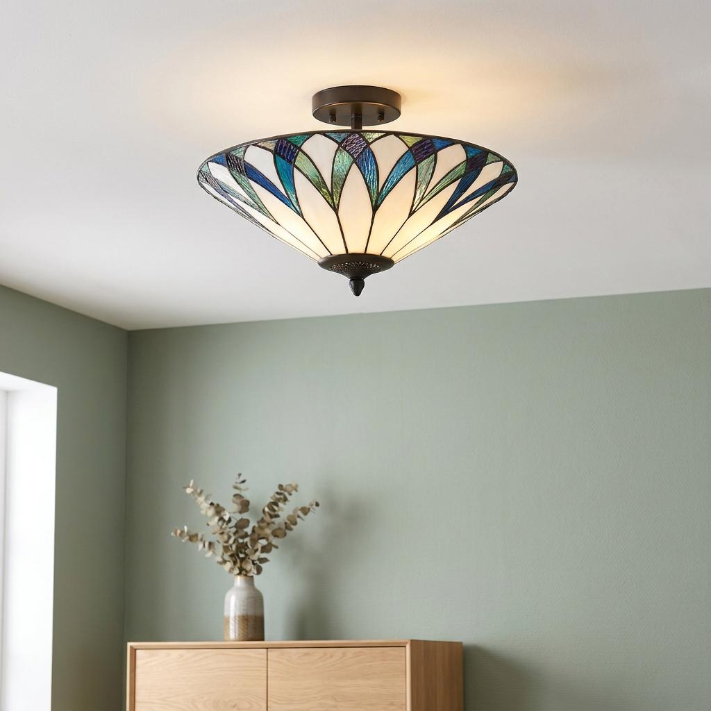 Semi-flush Tiffany ceiling light with blue and green stained glass shade mounted in a minimalist room.
