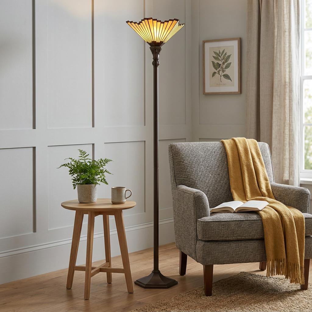 Tiffany style uplighter floor lamp with fan-shaped amber glass shade in a neutral living room.