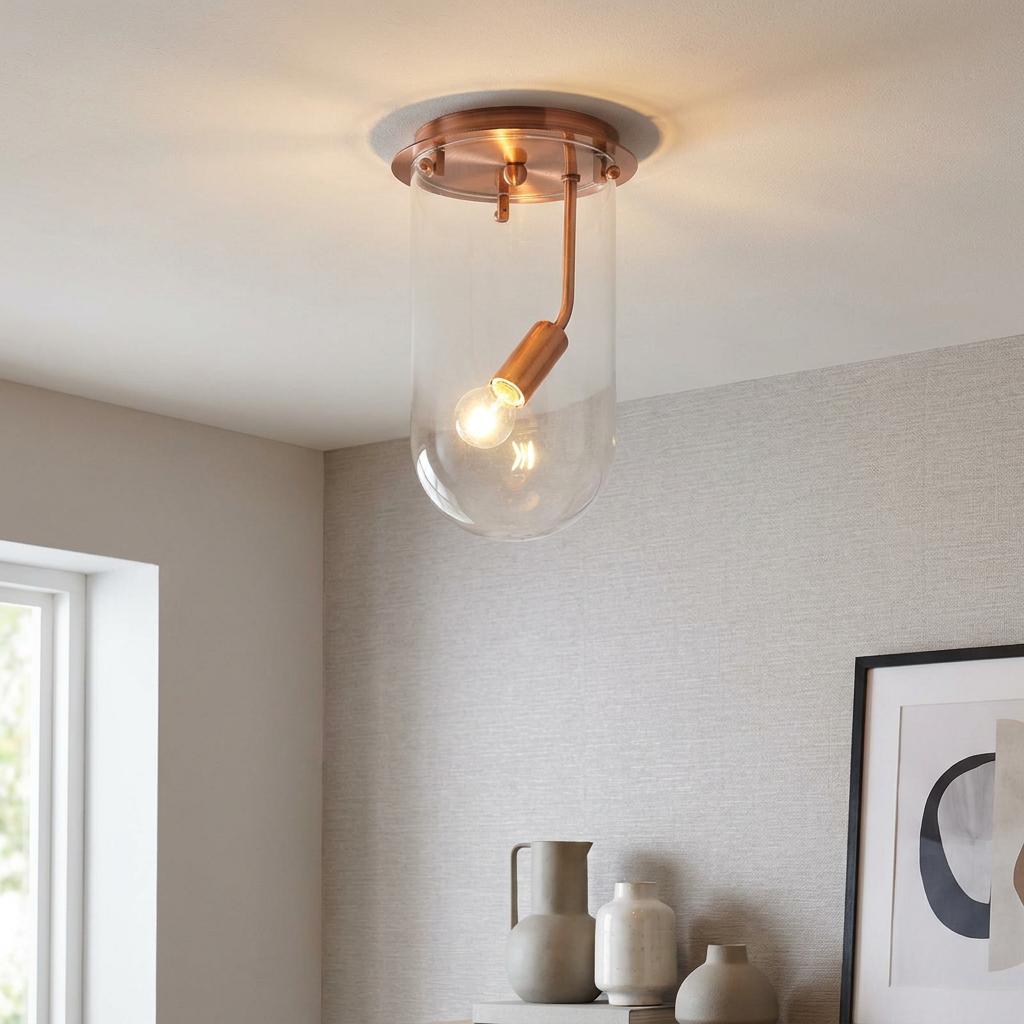 Mack copper and clear glass cylinder flush ceiling light illuminated in a modern interior.
