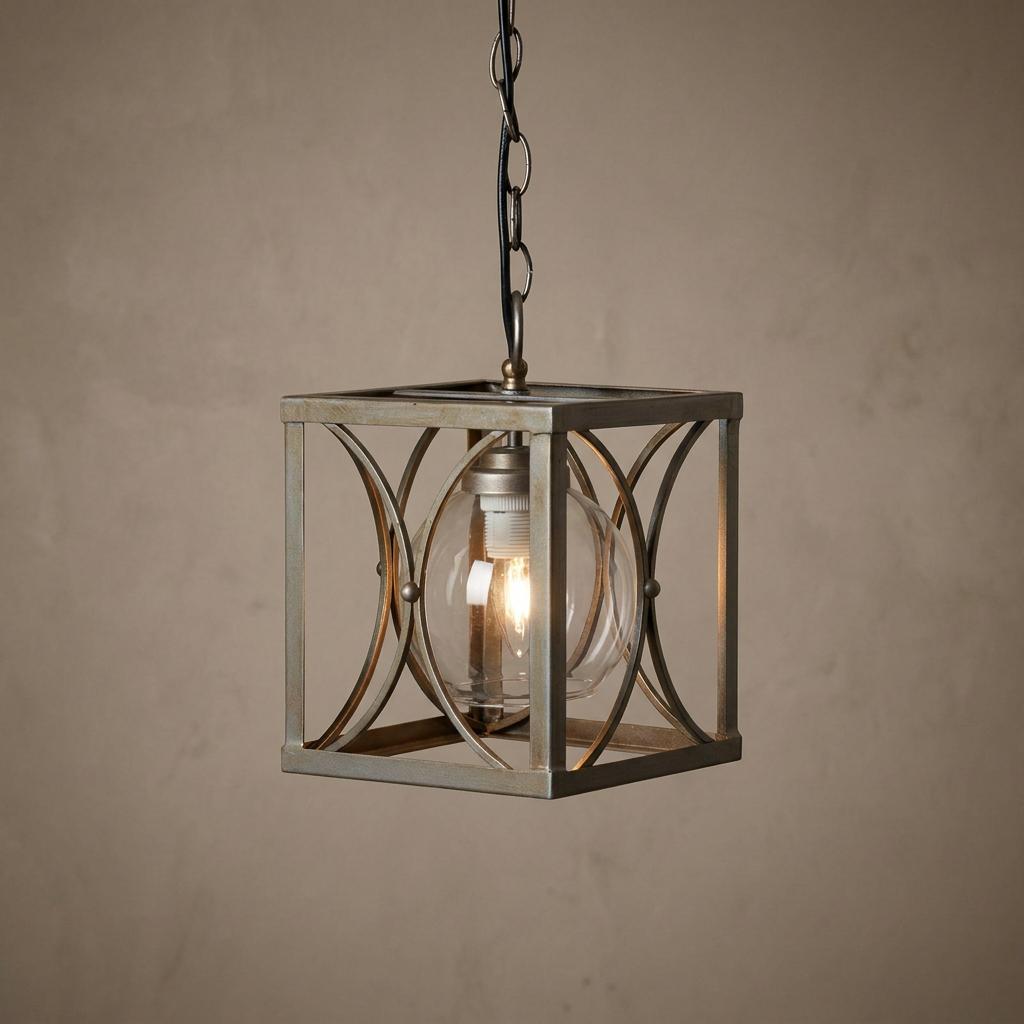 Matt silver square lantern pendant light with an internal glass globe and lit bulb hanging from a chain.