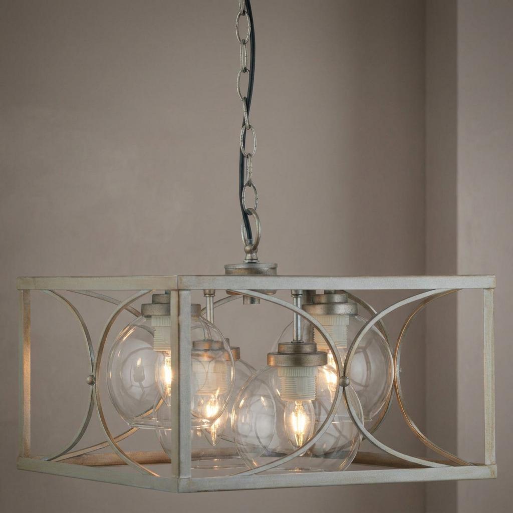 Matt silver rectangular ceiling pendant featuring four glass globe lights and decorative circular metalwork.