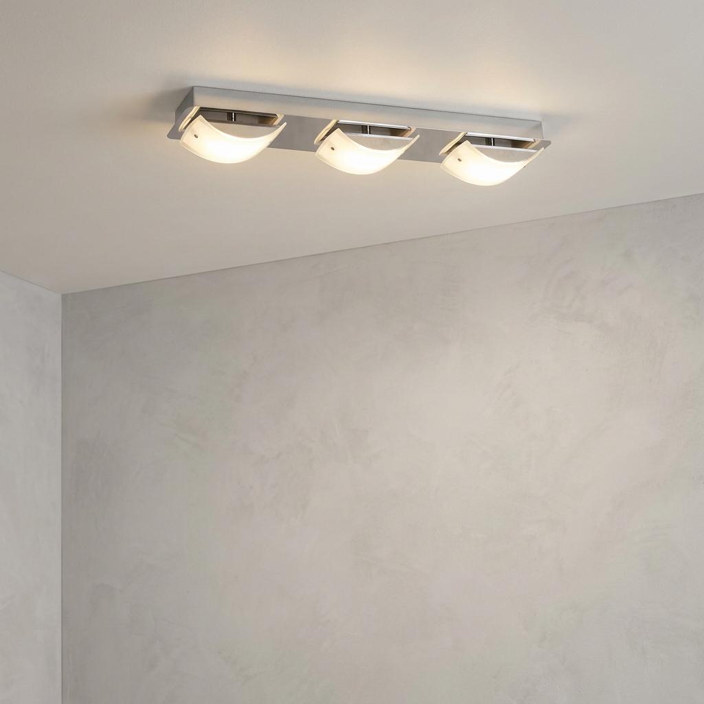 Modern three-light chrome LED ceiling fixture with curved frosted glass shades on a light gray ceiling.