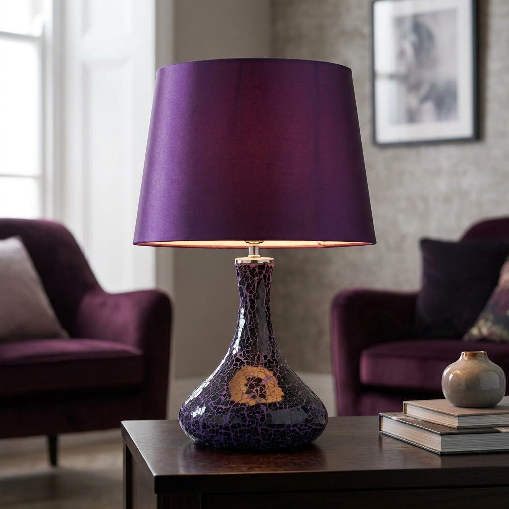 Oaks Zara mirrored mosaic table lamp with a purple shade on a dark wooden table in a living room setting.