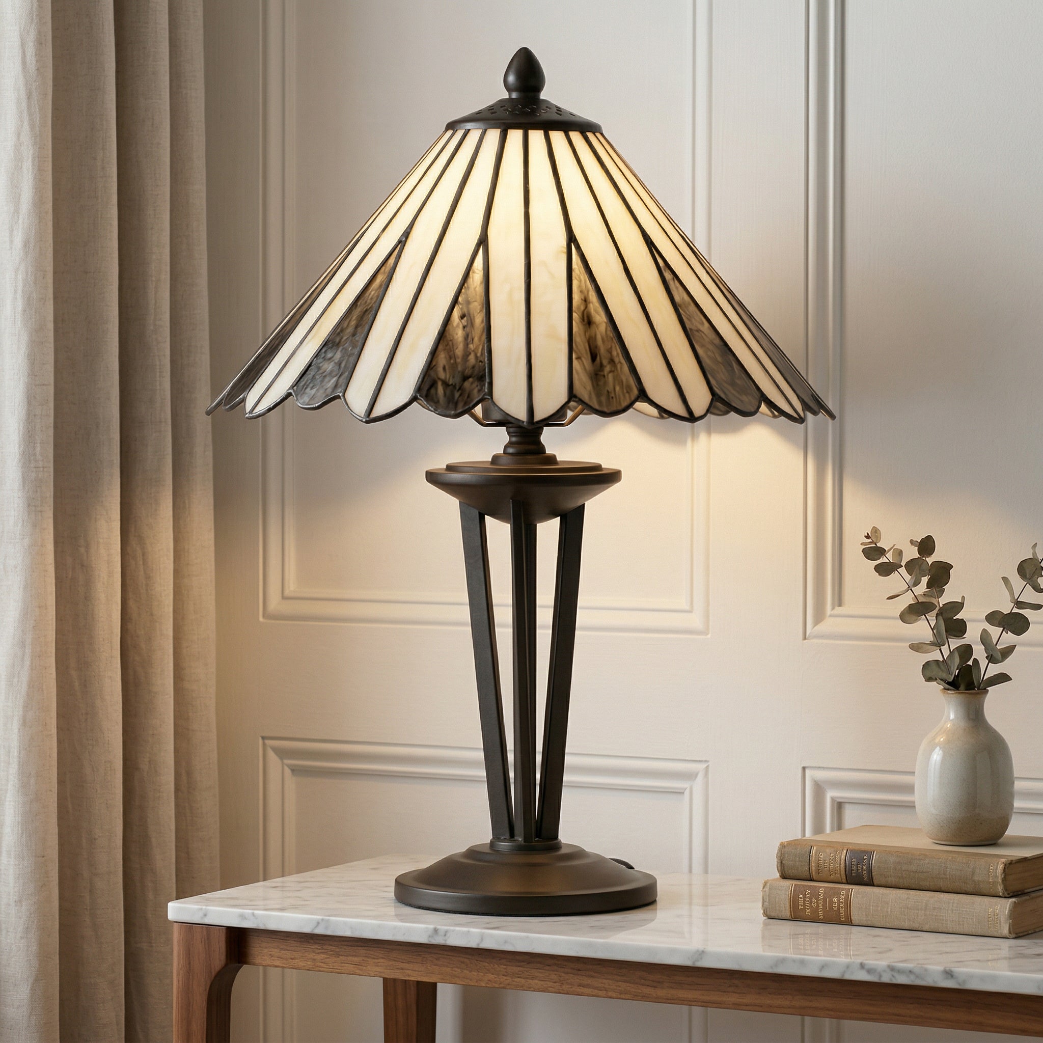 Decorative table lamp with stained glass shade on a marble surface