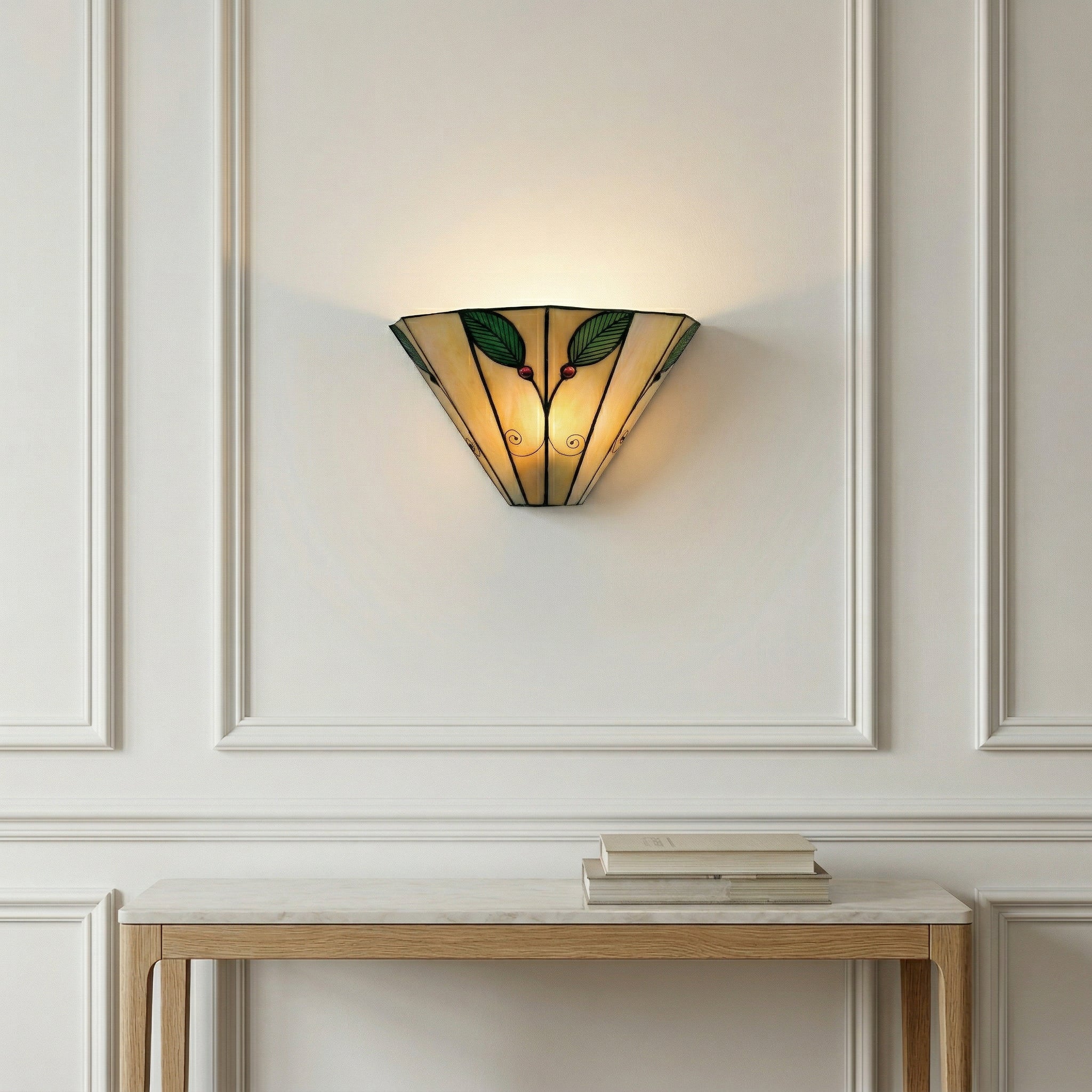 Decorative wall sconce with stained glass design on a white paneled wall.