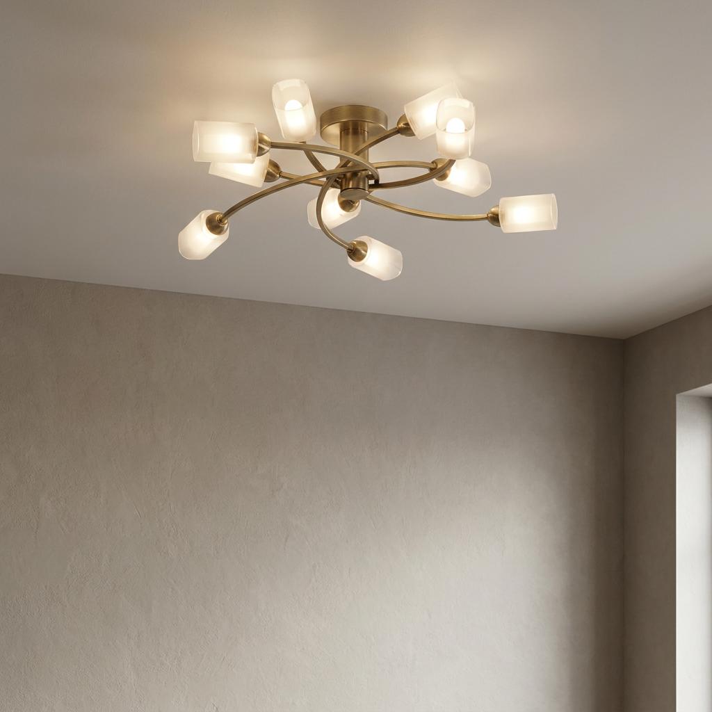 Ofira 10-light antique brass flush ceiling light with curved arms and glowing opal glass shades.