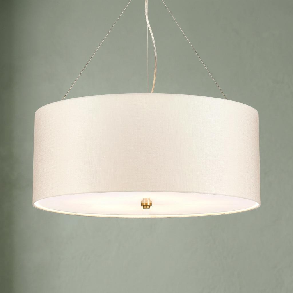 Glowing off-white drum pendant lamp with brass detail and thin suspension wires against a sage green background.