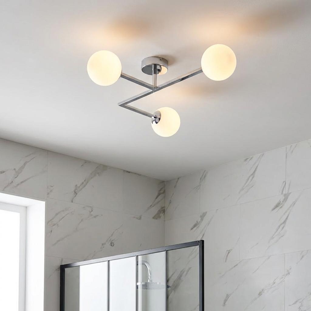 Pendle chrome 3-light semi-flush bathroom ceiling light with opal glass globes in a marble-tiled bathroom.