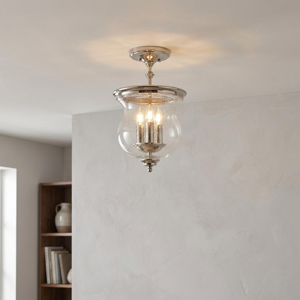 Polished nickel semi flush light with a seeded glass bell shade and three bulbs, mounted on a neutral ceiling.