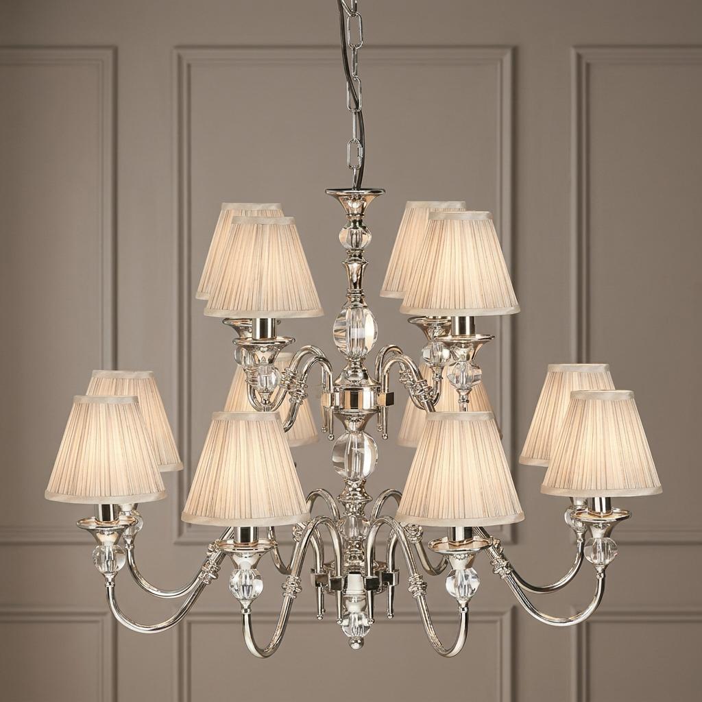 Polina 12-light polished nickel chandelier with pleated beige shades and crystal details on a paneled wall.