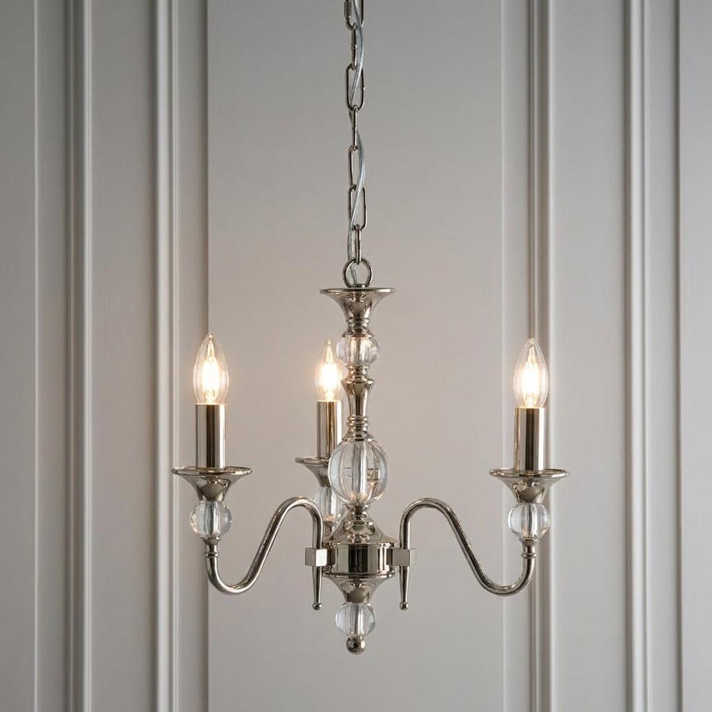 Polina 3-light polished nickel chandelier with clear crystal spheres and lit candle bulbs against a paneled wall.
