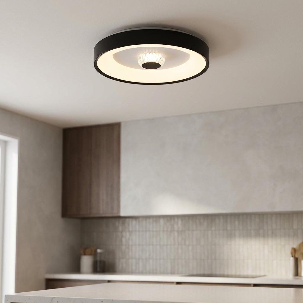 Modern matt black flush ceiling light with illuminated LED ring and crystal center in a kitchen setting.