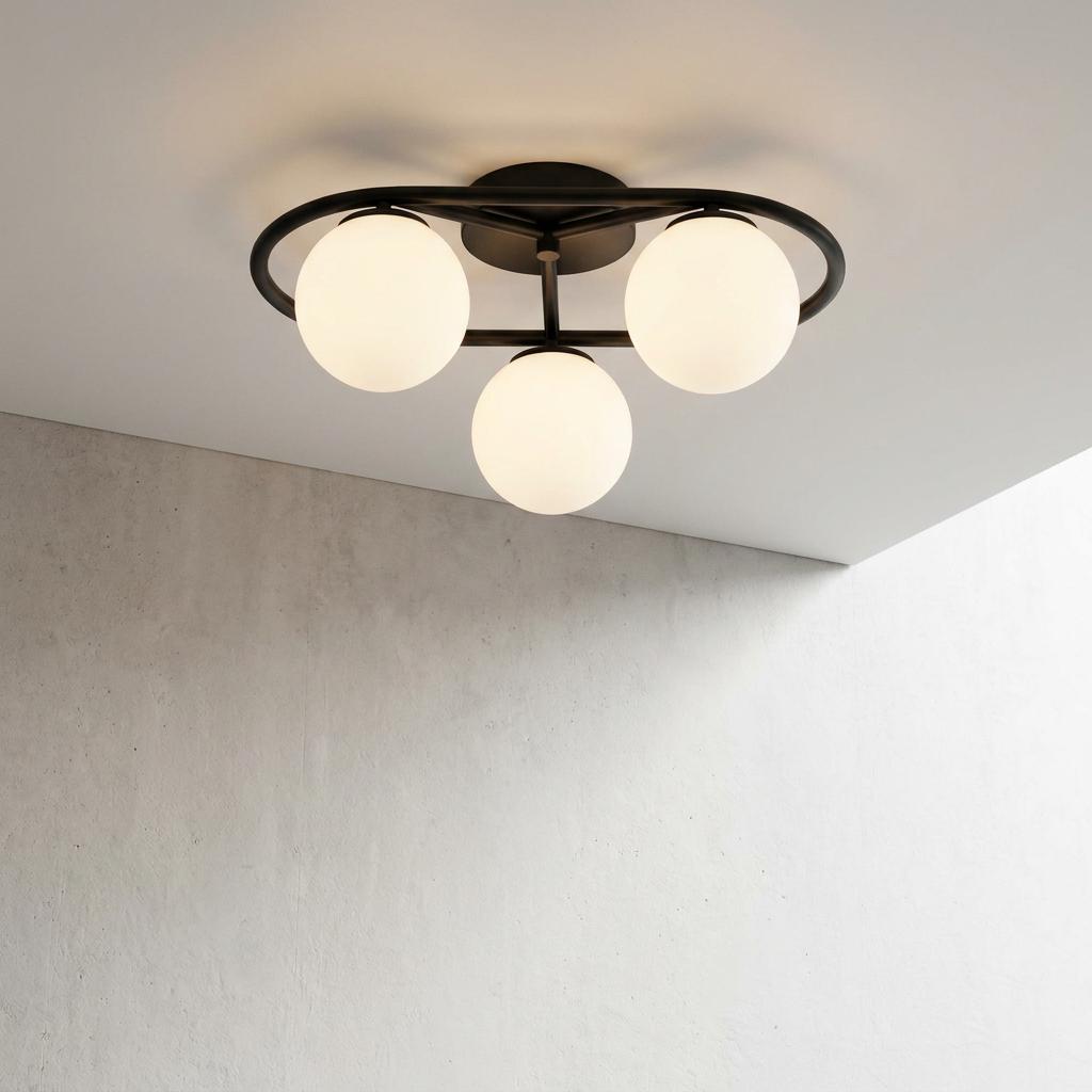Black Pulsa 3 light semi-flush ceiling light with three glowing opal glass globes on a white ceiling.