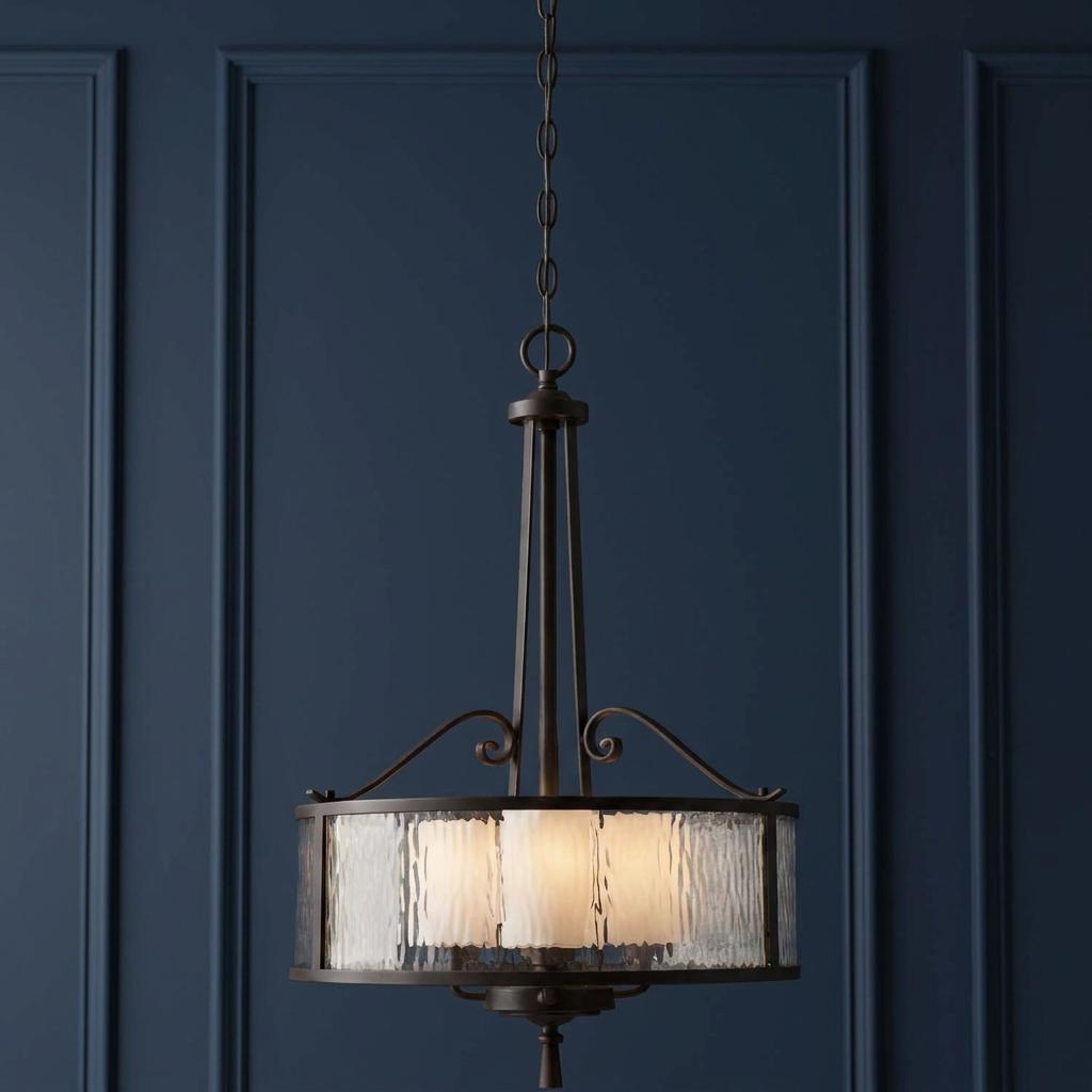 Quoizel Adonis 3-light pendant with dark cherry finish and hammered glass shade against a dark blue paneled wall.